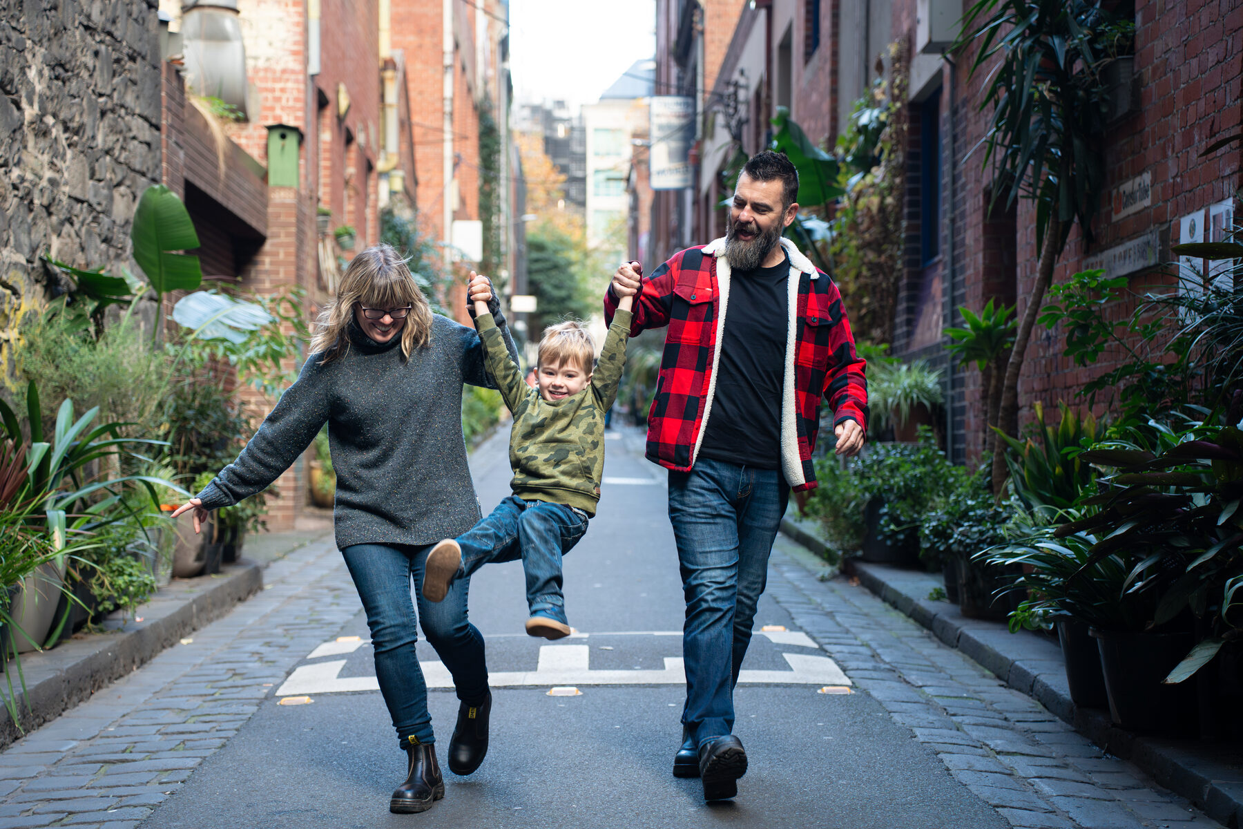 Anglo-Australian family walking through a Melbourne laneway
